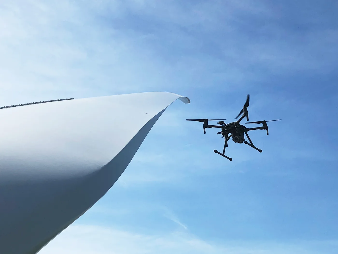 Drone inspecting wind turbine rotor blade